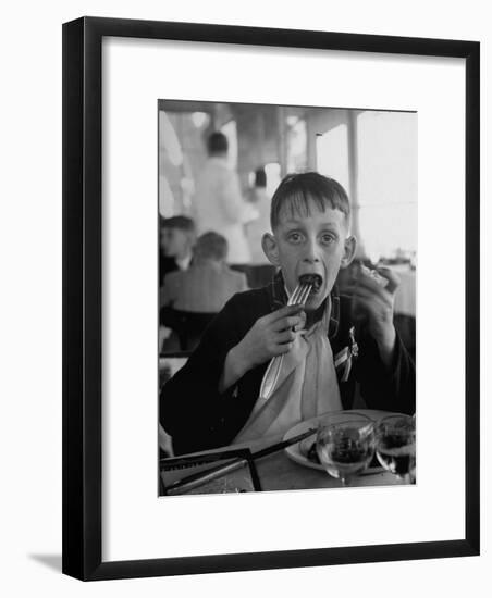 French Boy Andre Poindeeault Mastering a Big Bite-Nat Farbman-Framed Photographic Print