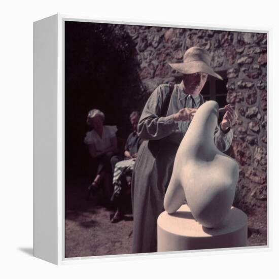 French Sculptor Jean Arp, Alone, Polishing Abstract Sculpture in His Garden Near Paris-Gjon Mili-Framed Premier Image Canvas