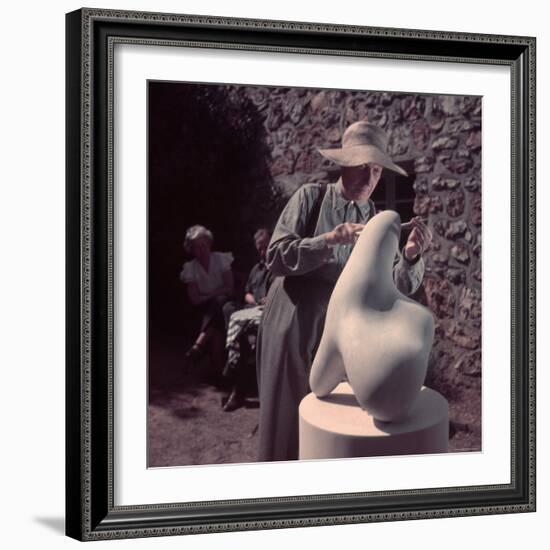 French Sculptor Jean Arp, Alone, Polishing Abstract Sculpture in His Garden Near Paris-Gjon Mili-Framed Premium Photographic Print