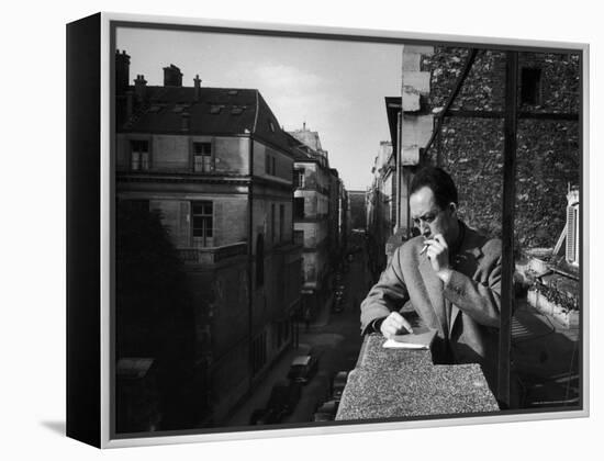 French Writer Albert Camus Smoking Cigarette on Balcony Outside His Publishing Firm Office-Loomis Dean-Framed Premier Image Canvas