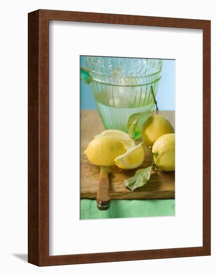 Fresh Lemons with Leaves in Front of Water Jug-Foodcollection-Framed Photographic Print