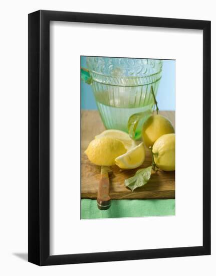 Fresh Lemons with Leaves in Front of Water Jug-Foodcollection-Framed Photographic Print