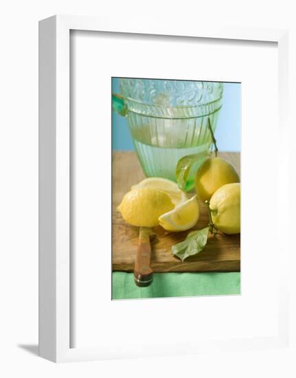 Fresh Lemons with Leaves in Front of Water Jug-Foodcollection-Framed Photographic Print