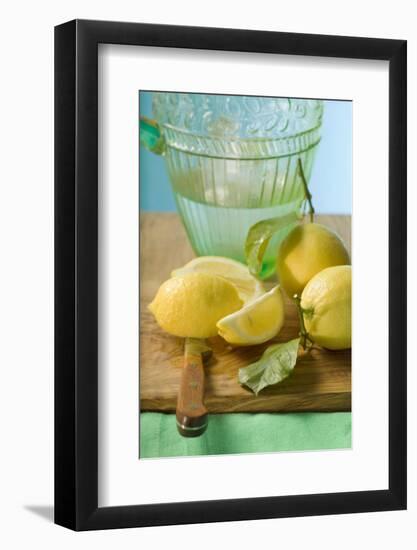 Fresh Lemons with Leaves in Front of Water Jug-Foodcollection-Framed Photographic Print