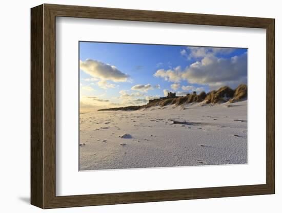 Fresh Spring Snow at Dawn Highlight Ripples and Marks in the Sand Beneath Bamburgh Castle-Eleanor-Framed Photographic Print