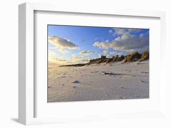 Fresh Spring Snow at Dawn Highlight Ripples and Marks in the Sand Beneath Bamburgh Castle-Eleanor-Framed Photographic Print