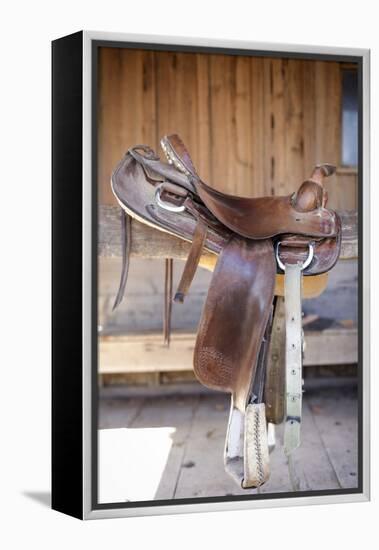 Full view of a Saddle resting on the railing, Tucson, Arizona, USA.-Julien McRoberts-Framed Premier Image Canvas