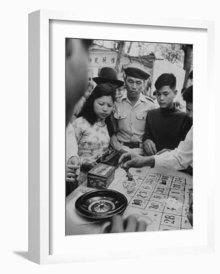 Game of Roulette at Fair in Central Highlands Celebrating New Year's Holiday-John Dominis-Framed Photographic Print