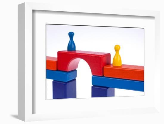 Gaming Pieces and Building Blocks Symbolising Breaking Down Barriers-Catharina Lux-Framed Photographic Print