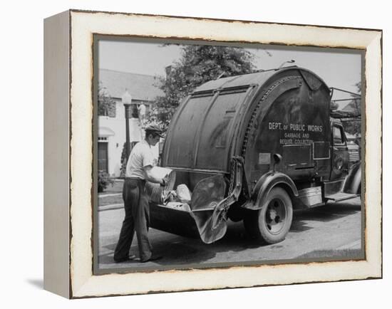 Garbage Man Emptying Trash into Back of Garbage Truck-Alfred Eisenstaedt-Framed Premier Image Canvas