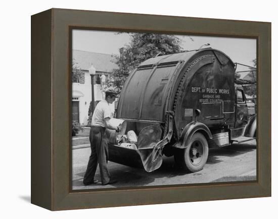 Garbage Man Emptying Trash into Back of Garbage Truck-Alfred Eisenstaedt-Framed Premier Image Canvas