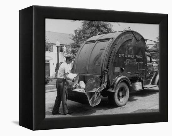 Garbage Man Emptying Trash into Back of Garbage Truck-Alfred Eisenstaedt-Framed Premier Image Canvas