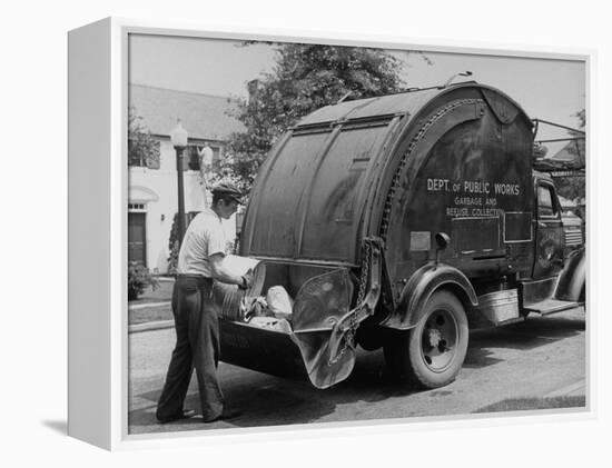 Garbage Man Emptying Trash into Back of Garbage Truck-Alfred Eisenstaedt-Framed Premier Image Canvas