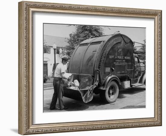 Garbage Man Emptying Trash into Back of Garbage Truck-Alfred Eisenstaedt-Framed Photographic Print