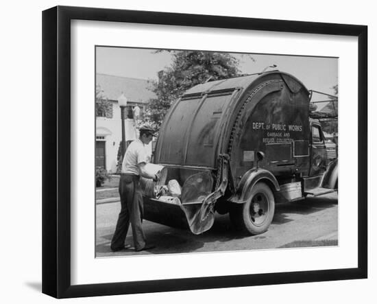 Garbage Man Emptying Trash into Back of Garbage Truck-Alfred Eisenstaedt-Framed Photographic Print
