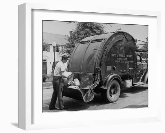 Garbage Man Emptying Trash into Back of Garbage Truck-Alfred Eisenstaedt-Framed Photographic Print