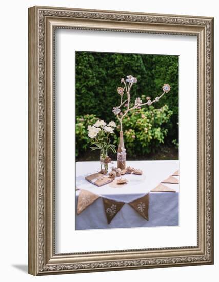 Garden table, Easter decoration, flowers, fork, jute, Easter eggs,-mauritius images-Framed Photographic Print