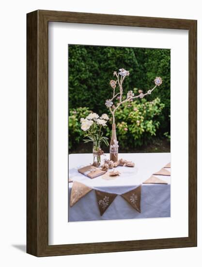 Garden table, Easter decoration, flowers, fork, jute, Easter eggs,-mauritius images-Framed Photographic Print