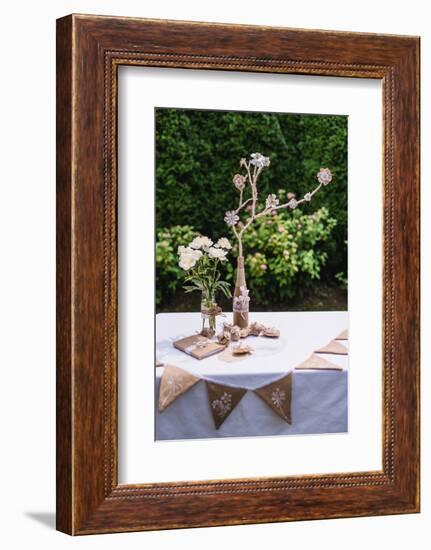 Garden table, Easter decoration, flowers, fork, jute, Easter eggs,-mauritius images-Framed Photographic Print