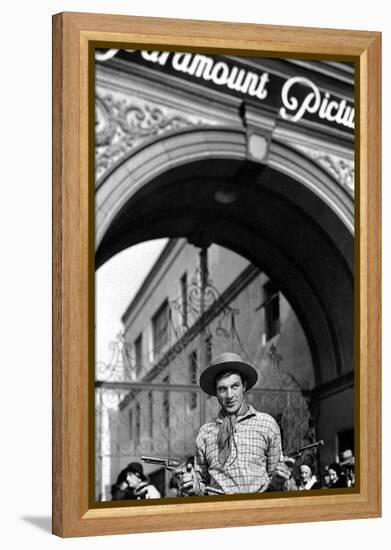 Gary Cooper poses with revolvers in his hands-null-Framed Stretched Canvas