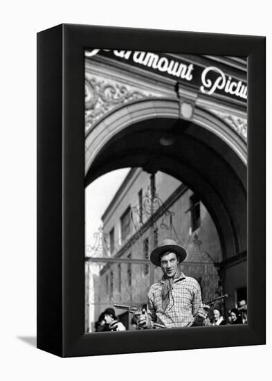 Gary Cooper poses with revolvers in his hands-null-Framed Stretched Canvas