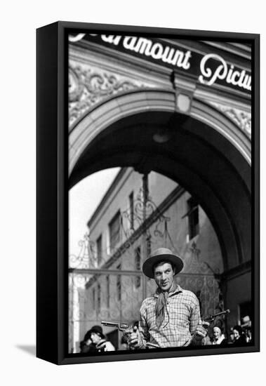 Gary Cooper poses with revolvers in his hands-null-Framed Stretched Canvas