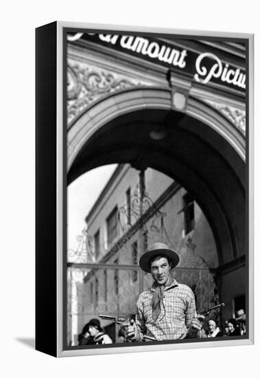 Gary Cooper poses with revolvers in his hands-null-Framed Stretched Canvas