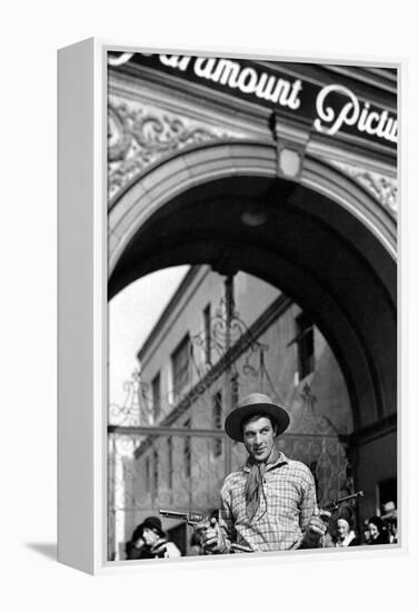 Gary Cooper poses with revolvers in his hands-null-Framed Stretched Canvas