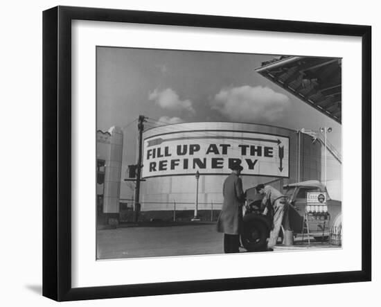 Gas Station Attendant Changing Oil for a Customer Next to Fill Up at the Refinery Sign-Margaret Bourke-White-Framed Photographic Print