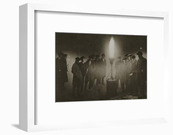 Gathering around an acetylene flare at a traffic control point in the fog, early 20th century-Unknown-Framed Photographic Print