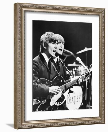 George Harrison (Left) and John Lennon of the Beatles-null-Framed Photo