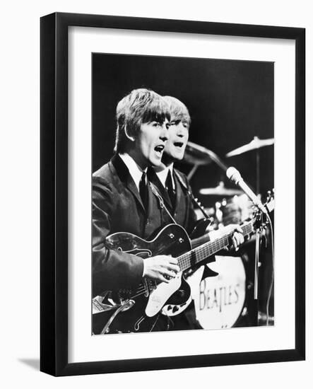 George Harrison (Left) and John Lennon of the Beatles-null-Framed Photo