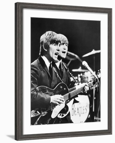 George Harrison (Left) and John Lennon of the Beatles-null-Framed Photo