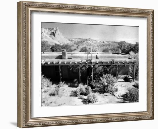 Georgia O'Keeffe Climbing a Ladder Outside Ghost Ranch, Her Desert Home-John Loengard-Framed Photographic Print