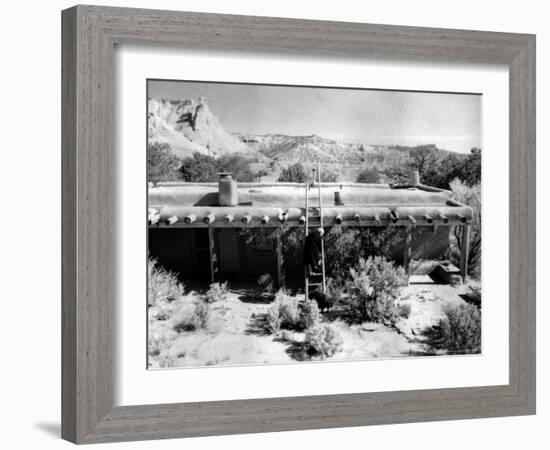 Georgia O'Keeffe Climbing a Ladder Outside Ghost Ranch, Her Desert Home-John Loengard-Framed Photographic Print