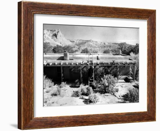 Georgia O'Keeffe Climbing a Ladder Outside Ghost Ranch, Her Desert Home-John Loengard-Framed Photographic Print