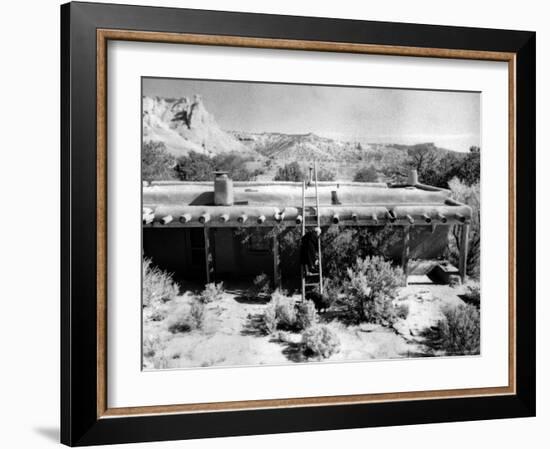 Georgia O'Keeffe Climbing a Ladder Outside Ghost Ranch, Her Desert Home-John Loengard-Framed Photographic Print