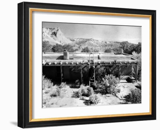 Georgia O'Keeffe Climbing a Ladder Outside Ghost Ranch, Her Desert Home-John Loengard-Framed Photographic Print