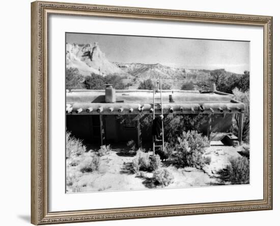 Georgia O'Keeffe Climbing a Ladder Outside Ghost Ranch, Her Desert Home-John Loengard-Framed Photographic Print