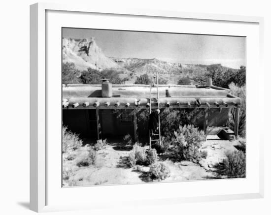 Georgia O'Keeffe Climbing a Ladder Outside Ghost Ranch, Her Desert Home-John Loengard-Framed Photographic Print