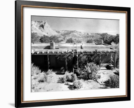 Georgia O'Keeffe Climbing a Ladder Outside Ghost Ranch, Her Desert Home-John Loengard-Framed Photographic Print