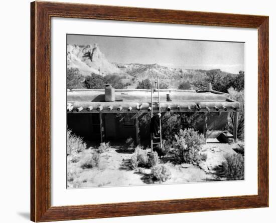 Georgia O'Keeffe Climbing a Ladder Outside Ghost Ranch, Her Desert Home-John Loengard-Framed Photographic Print