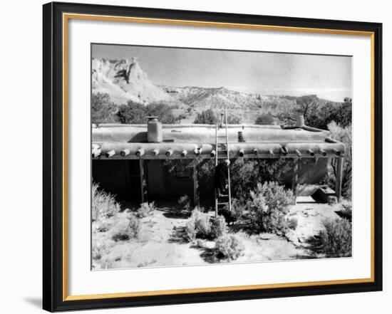 Georgia O'Keeffe Climbing a Ladder Outside Ghost Ranch, Her Desert Home-John Loengard-Framed Photographic Print