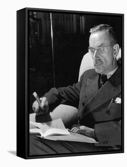 German Born Novelist Thomas Mann Sitting in Armchair at Home, Smoking Cigar and Reading a Book-Carl Mydans-Framed Premier Image Canvas