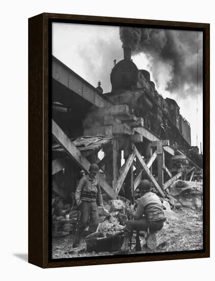 Gi Infantry Guards Keeping Warm by a Fire Next to an Army Engineer Built Railroad Bridge-Ralph Morse-Framed Premier Image Canvas