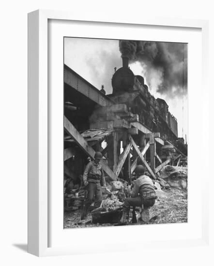 Gi Infantry Guards Keeping Warm by a Fire Next to an Army Engineer Built Railroad Bridge-Ralph Morse-Framed Photographic Print