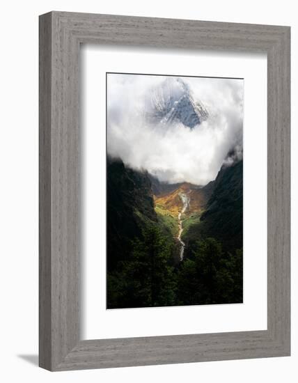 Giant mountain emerging through the clouds in the Himalayas, Nepal on the way to Everest Base Camp-David Chang-Framed Photographic Print