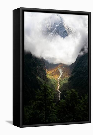 Giant mountain emerging through the clouds in the Himalayas, Nepal on the way to Everest Base Camp-David Chang-Framed Premier Image Canvas