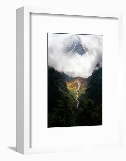Giant mountain emerging through the clouds in the Himalayas, Nepal on the way to Everest Base Camp-David Chang-Framed Premium Photographic Print