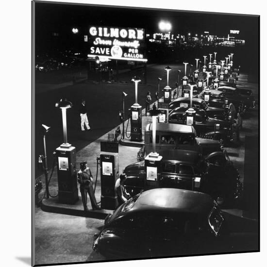 Gilmore Gas Station Featuring Eight Islands, Three Pumps Each, Girl Makes Change Every Two Islands-Allan Grant-Mounted Photographic Print